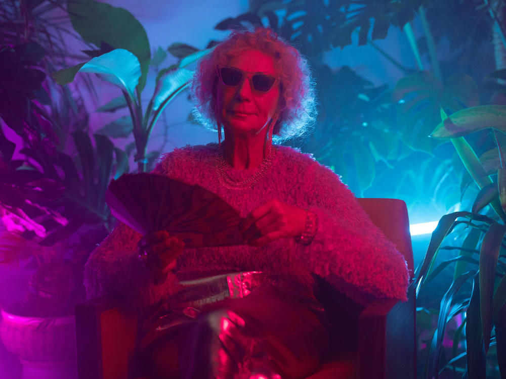 Making fun of the myth that you need a lot of money to start saving, a Canadian senior fans out a wad of cash at a club.